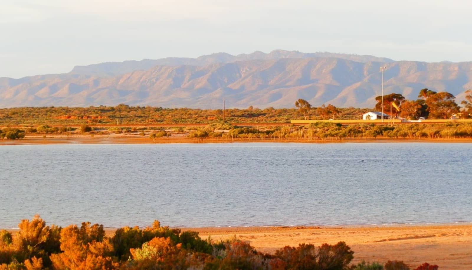 Spencer Gulf in Port Augusta, South Australia, backed by the dramatic, sunlit peaks of the Flinders Ranges in South Australia.