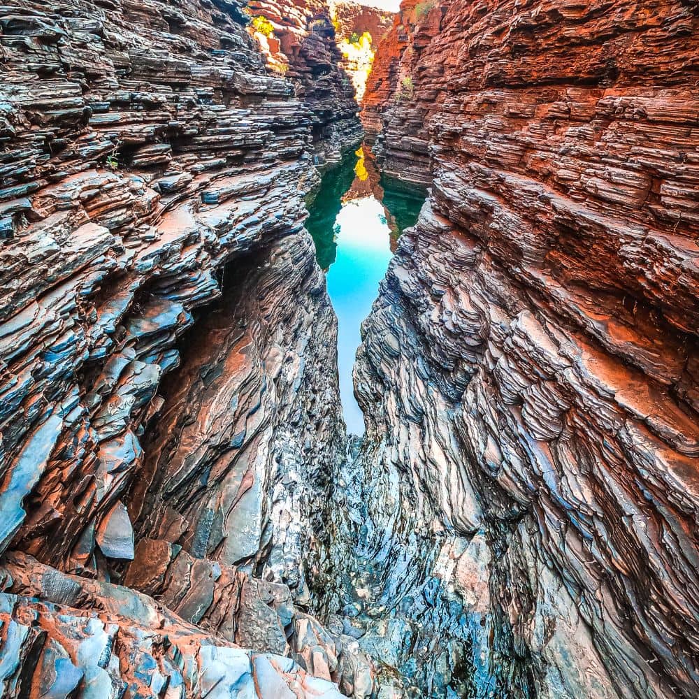 Intricate and almost symmetrical rock formation with clear blue water amongst it. If you go to Karijini, this is something you have to see. Joffre Gorge in Karijini is very popular.