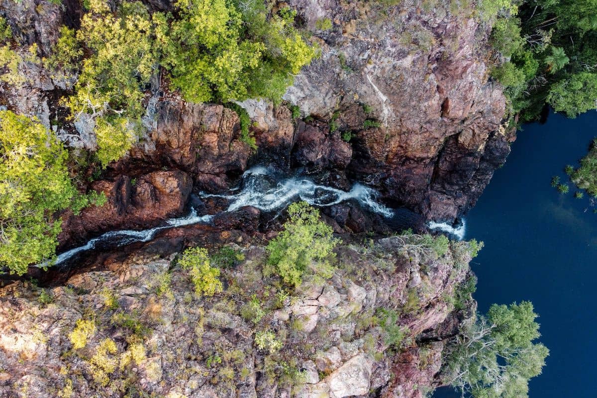 An overhead view of a water flowing onto a body of water. One of the many sites you see while on one of Litchfield National Parks best walks.