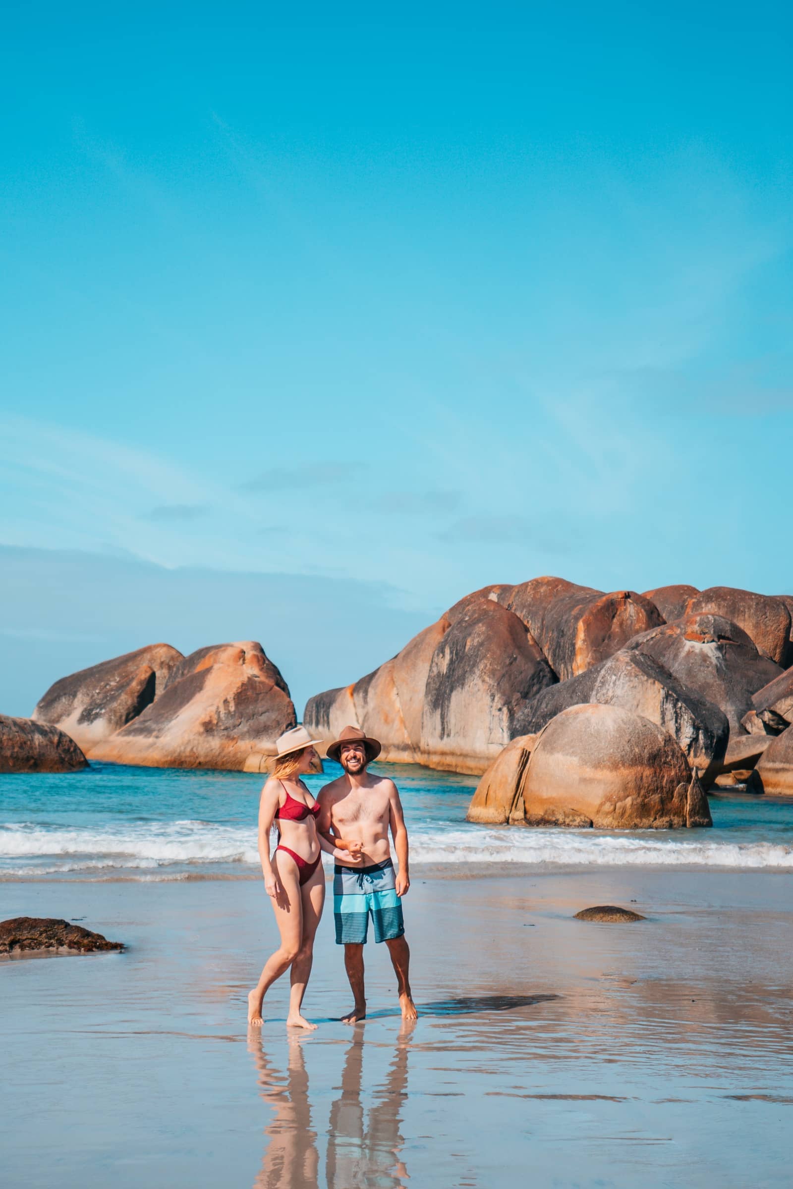a happy couple in their swimming attire enjoying the beach in Elephant Rocks Denmark Western Australia