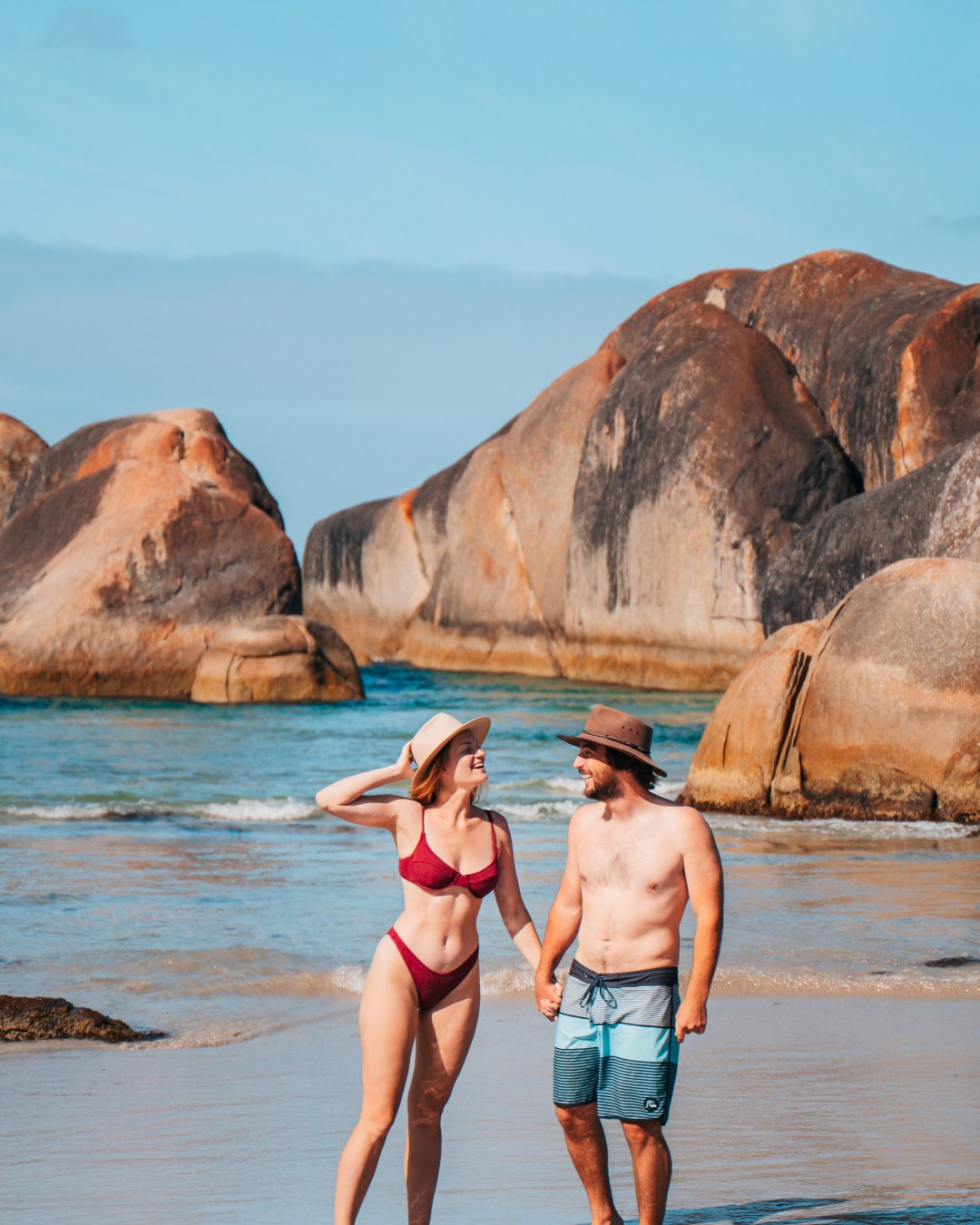 a happy couple in their swimming attire enjoying a sunny day at the beach in Elephant Rocks Denmark Western Australia