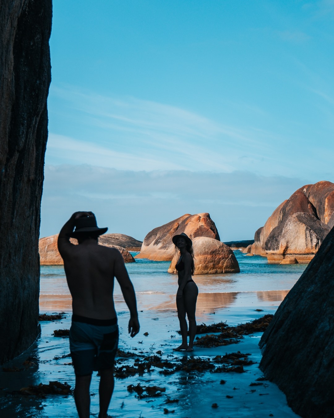 couple in their swimming attire walking to the beach in Elephant Rocks Denmark Western Australia