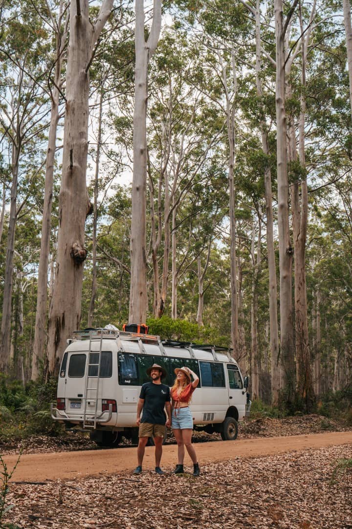 Happy Couple behind a van camping Boranup Forest, one of the best things to do in Margaret River, Western Australia