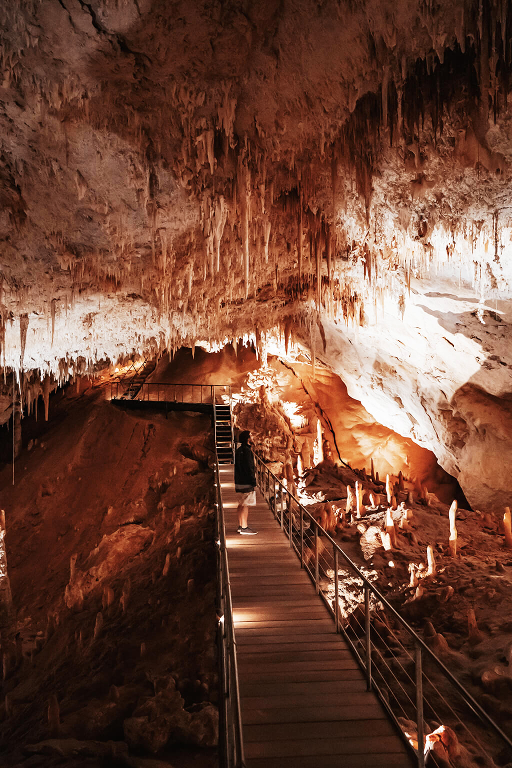 Man watching Margaret River's Underground Cave stalactites and stalagmites in Western Australia