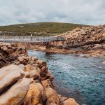 A woman on the bridge enjoying the scenic view at the Canal Rocks Margaret River, Western Australia