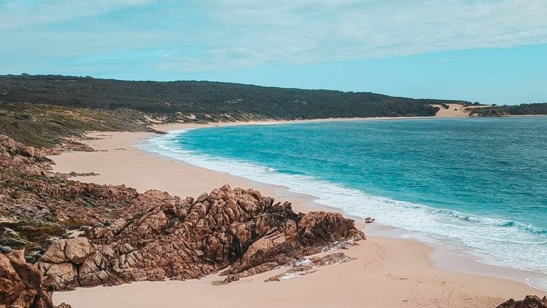 A secluded beach in the Yallingup area, featuring rugged rock formations, golden sand, and clear blue waters. It shows one of the best beaches in Margaret River region.