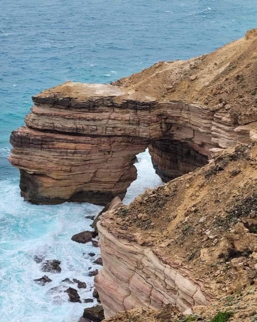 Natural Bridge in Kalbarri, Western Australia, with waves crashing against the rocky arch formation.