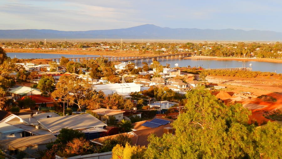 Aerial view of Port Augusta with Spencer Gulf and distant mountains. Discover things to do in Port Augusta amidst this scenic landscape.