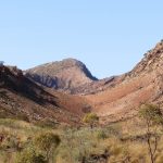 Rocky gorge surrounded by grassy hills on the Ormiston Gorge and Pound Walk, a top activity when exploring things to do in Central Australia.