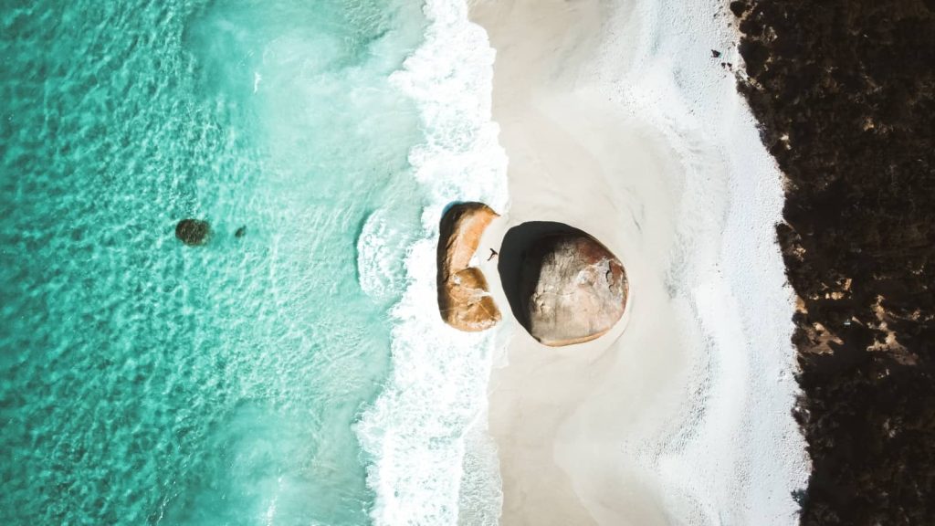 Aerial view of the turquoise waves crashing at Greens Pool, a white sandy beach in Western Australia, a stunning coastal stop along a Perth to Albany road trip.