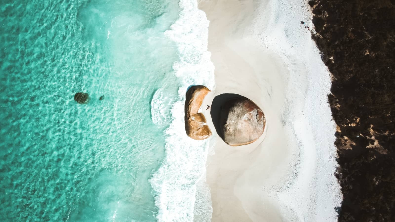 Aerial view of the turquoise waves crashing at Greens Pool, a white sandy beach in Western Australia, a stunning coastal stop along a Perth to Albany road trip.