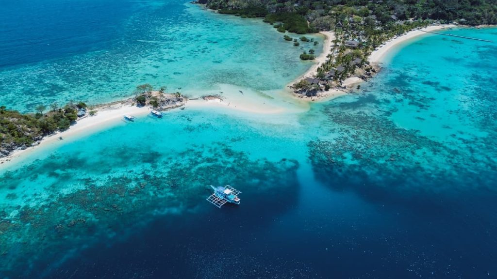 Aerial view of Bulog Dos Island with white sandbars and turquoise water, one of the most beautiful things to do in Coron, Philippines.
