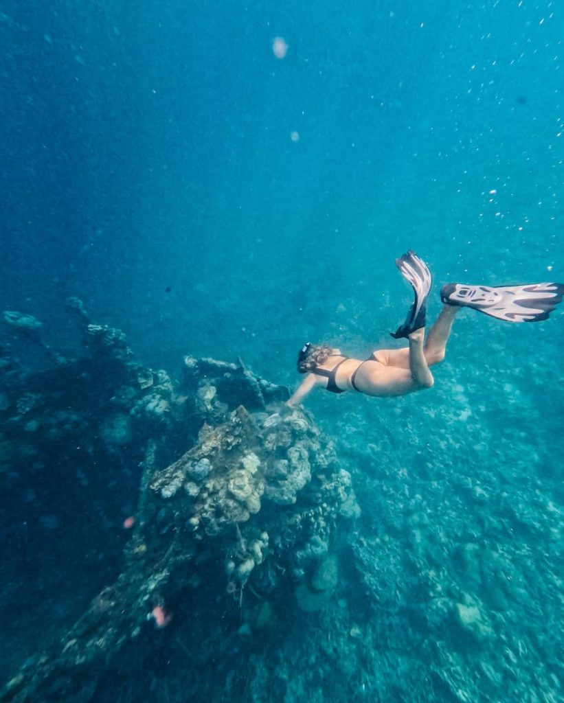 Woman snorkelling over the Lusong Gunboat Wreck, one of the most fascinating things to do in Coron, Philippines for history and underwater lovers.