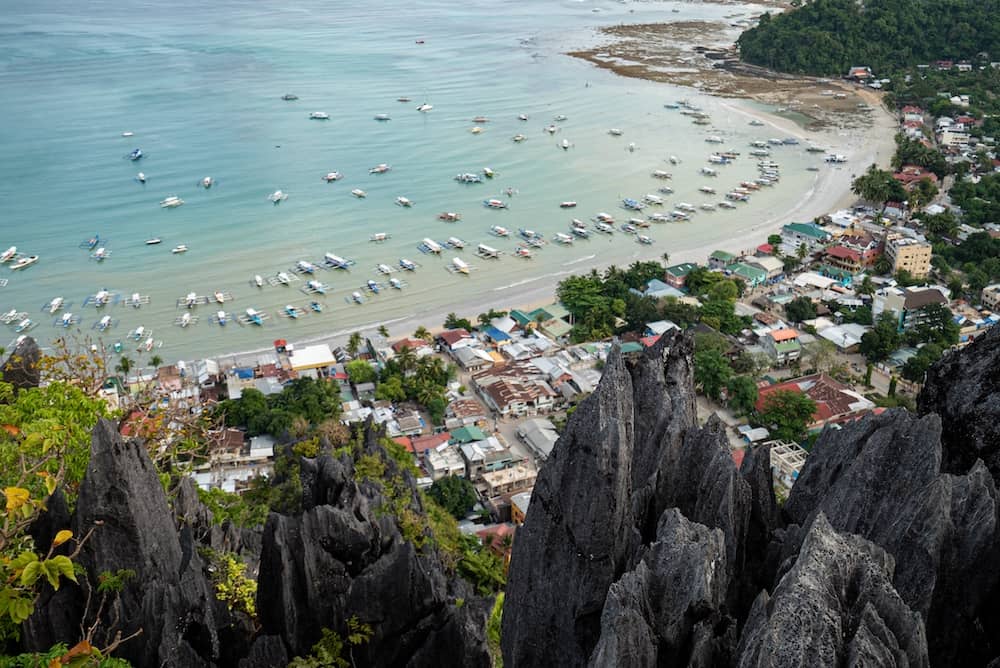View from a limestone peak overlooking the beach and town of El Nido, Palawan