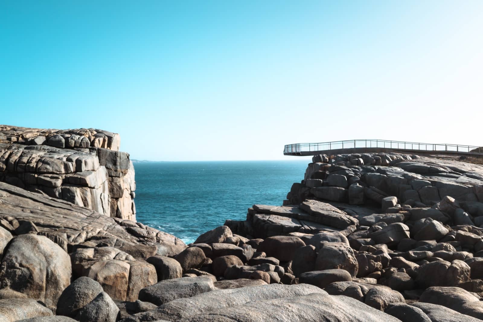 A scenic ocean lookout with a curved metal viewing platform perched over The Gap in Albany, South West Australia. Coastal viewpoints like this are essential stops on a south west australia road trip 7 days.