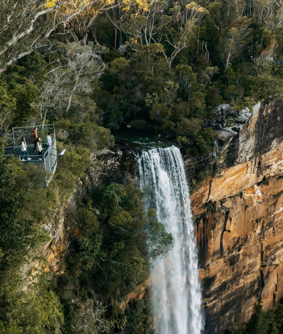 Fitzroy Falls drops into a forested sandstone gorge in Morton National Park, with a viewing platform on the cliff edge, a highlight of a Southern Highlands road trip.