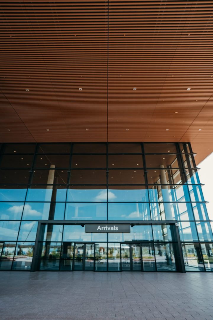 The glass Arrivals entrance of the new Western Sydney International Airport terminal at Badgerys Creek, under its timber-slatted roof.